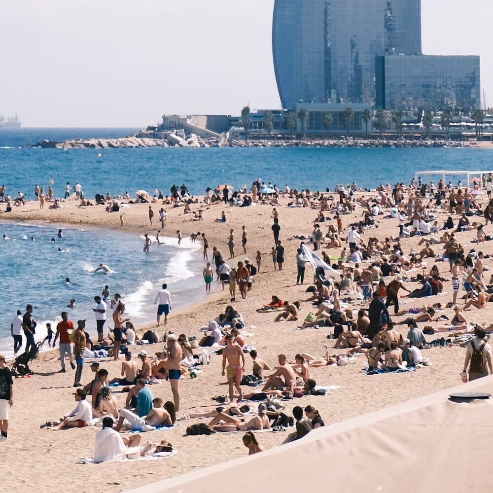 Barceloneta beach busy with sunbathers, the W hotel on the headland